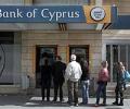 Cyprus reopens banks under tight restrictions