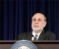 In Bernanke's final act, Fed cuts stimulus despite market turmoil