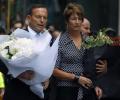 Australian PM Tony Abbott lays flowers at Sydney siege site