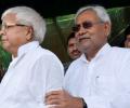 How does Nitish escape Lalu's boa constrictor-like embrace?