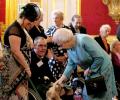 Queen's dogs eat dinners served by butlers on silver platters