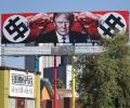 Now, a US billboard shows Trump with swastika-like symbols