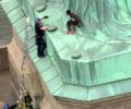 Woman climbs base of Statue of Liberty to protest Trump's immigration policy