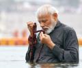 PM takes dip at Kumbh, washes feet of sanitation workers