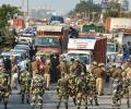 Security stepped up at Delhi border as farmers reach closer