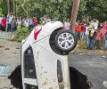 PHOTOS: Car swallowed by Delhi road in monsoon