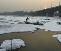 Delhi govt sprinkles water on Yamuna to remove froth