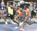 Bolt makes a splash with 100m win in rainy Toronto