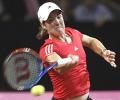 Henin overcomes fiery German in Stuttgart