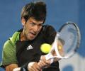 Djokovic advances after opponent withdraws 