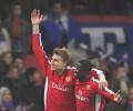 Bendtner's hat-trick sends Arsenal into quarters