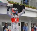 Button wins in wet Hungary on 200th start 