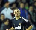 Benzema double helps Real keep Barca in sight 