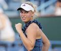 Wozniacki battles through, Clijsters out injured