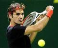 Rampant Federer crushes Davydenko, Nadal toils in Doha