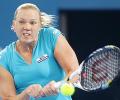 Clijsters eases into semis, Kanepi upsets Petkovic