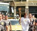 First Look: Big B carries Olympic flame in London