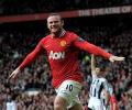 Rooney goals lift Man United top after City lose