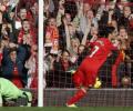 Suarez hat-trick keeps Liverpool on Arsenal's tail