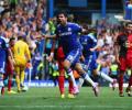 Costa hat-trick downs Swansea, City draw at Arsenal