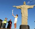 Torch begins final race to stadium from beneath Rio's Christ