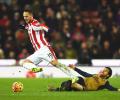 EPL PHOTOS: Arsenal go top after draw at Stoke; United win at Liverpool