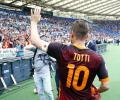 Totti penalty gives Roma a win in wet Serie A