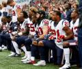 Trump Bullies NFL; fine for players on anthem protests