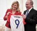 Croatian leader hands Putin soccer shirt before World Cup final