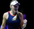 Wozniacki stays alive in Singapore; Federer survives scare