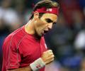 Federer cruises into last 16; Murray loses