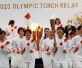 High fives, smiles but no cheers as Olympic torch relay gets going