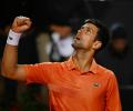 Djokovic keeps top spot after edging past Auger-Aliassime