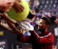 Djokovic struck on head by water bottle while signing autographs