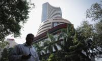 Sensex gains marginally to scale new peak