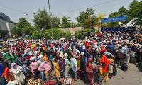 Hoping to go home, migrants walk to rlwy station daily