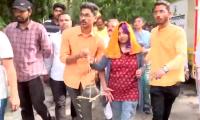 Daughter in blood-stained clothes leads victim's funeral