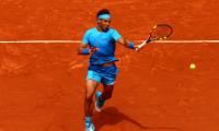 PHOTOS: Nadal dismisses Almagro; Injured Djokovic brushes Muller