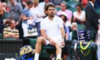 Laid low by sore knee, Wawrinka shown door by energetic Russian