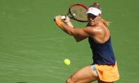 Kerber rallies to reach fourth round; Halep bows out