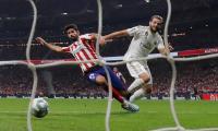 Real Madrid top La Liga after derby draw at Atletico