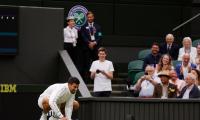 Wimbledon: Djokovic wipes slippery centre court 