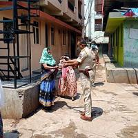A cop distributes rations to sex workers in Nagpur