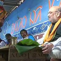 Amit Shah eyes a juicy rasgulla at a tribal's home in Bankura