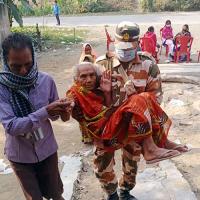 An elderly voter being carried to a poll station to cast her vote in Bihar