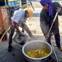 Farmers prepare a meal on the road to Delhi