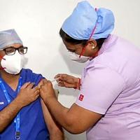 A healthcare worker is administered the Covid vaccine