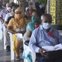 People wait to get vaccinated in Mumbai