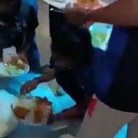 Video grab of the players being served food in a toilet