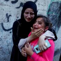 The daughter of a member of Hamas is comforted during her father's funeral. Reuters/Ibraheem Abu Mustafa